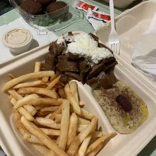 Lamb and Beef Gyro Combo Plate with fries and baba ghanoush. (Side order of falafel in back, you get three)