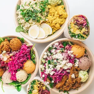 three bowls of food on a white surface