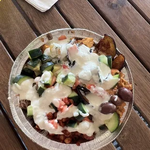 Chicken and beef bowl with various toppings