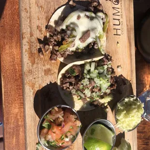 Asada taco and asada and green chile taco Shaved cabbage, lime, and pico