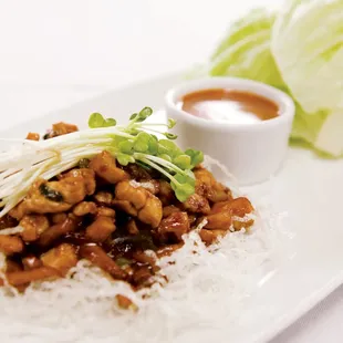 Lettuce Wraps - Fresh stir-fried chicken and vegetables, iceberg lettuce, crispy noodles &amp; peanut sauce.