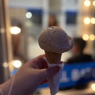 a hand holding an ice cream cone