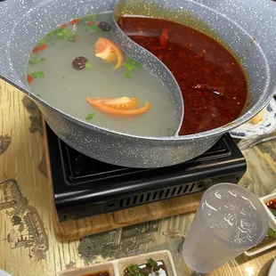 Hot pot for three people, all you can eat. This is just the two broths before the add ins. One broth base and the other hot and spicy.