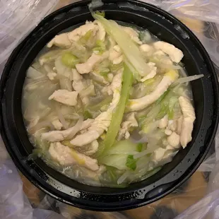 a bowl of soup with chicken and celery