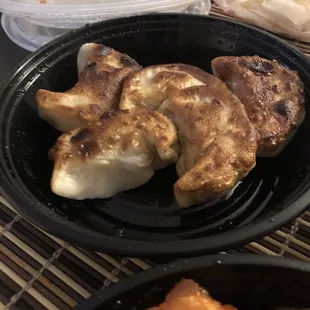 a bowl of dumplings and a bowl of chicken