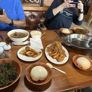 a man taking a picture of a table full of food