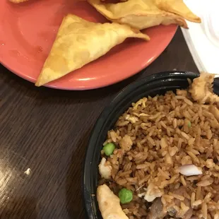a plate of fried rice and a bowl of fried tofu