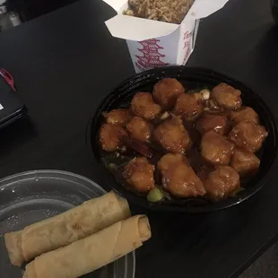 Orange chicken, fried rice, and spring rolls