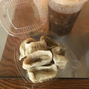a container of dumplings and a cup of coffee