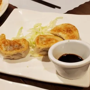 Pot Stickers w/thick skins and soy sauce dipping sauce.  Serving portion was 4.