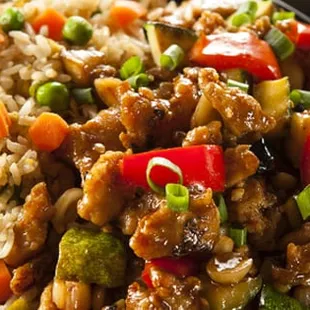 a plate of stir fried vegetables and rice