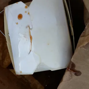 Grease coated container. So much oil in sauce it bled thru paper bag.