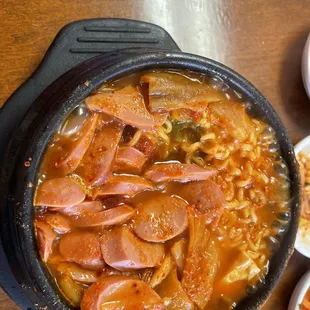 a bowl of soup with meat and vegetables
