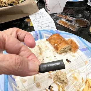 Not sure what this is, but it's plastic.  Probably fell off of something. However its unacceptable to bite into that while eating my moo sho