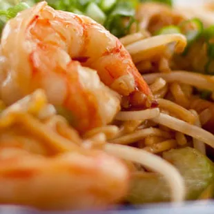 a plate of noodles and shrimp