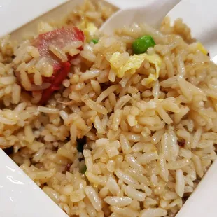 a bowl of fried rice with chopsticks