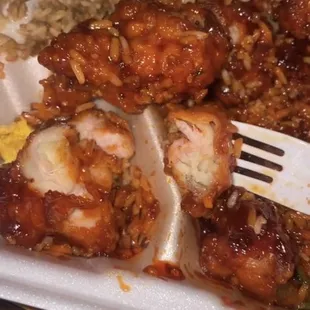 a plate of chicken and rice with a fork
