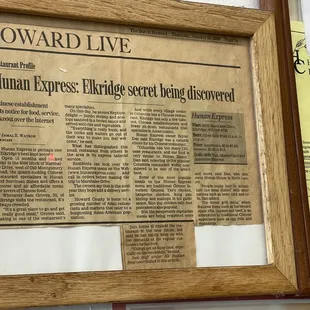 an old newspaper with a wooden frame