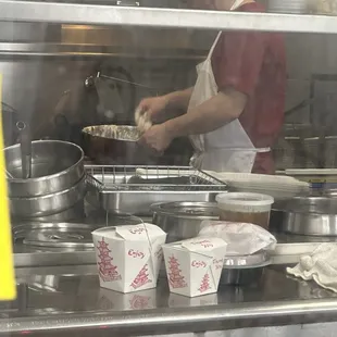 Wiping his sweaty face, and then sticking his hands in raw food with no gloves