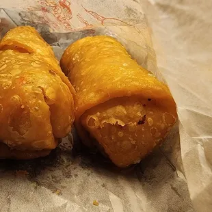 two pastries wrapped in wax paper