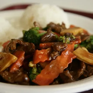 a plate of stir fried beef and broccoli