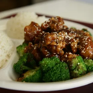 a plate of food with rice and broccoli