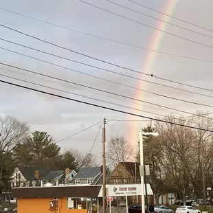 a rainbow over a parking lot