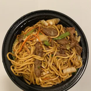 a bowl of noodles with meat and vegetables