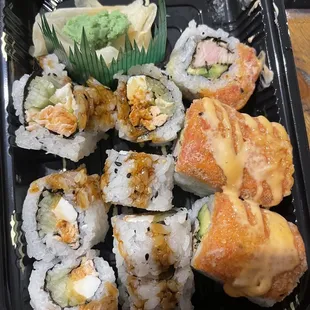 a tray of sushi and rolls