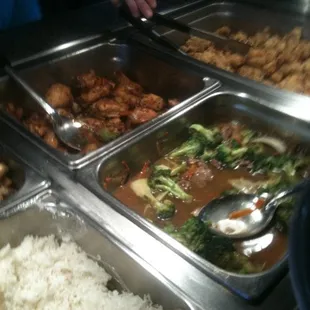 a variety of food items being served at a buffet