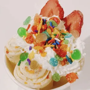 an ice cream sundae with fruit and sprinkles