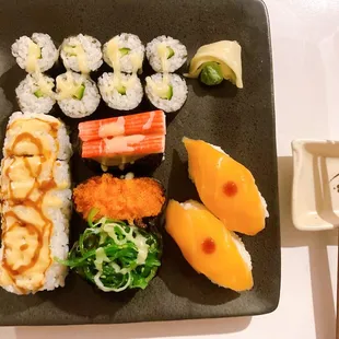 a plate of sushi and chopsticks