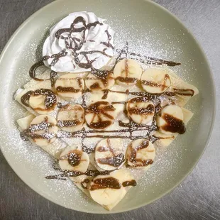 a plate of banana slices and whipped cream