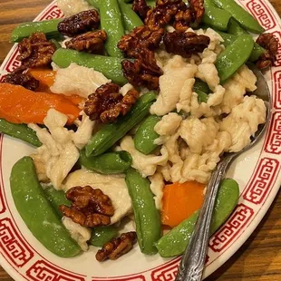 Chicken with sugar snap peas and candied walnuts