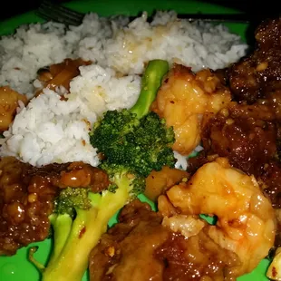 a plate of food with rice and broccoli