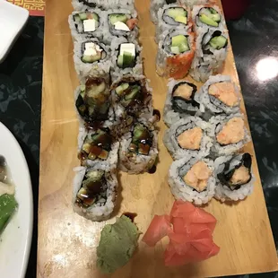 a variety of sushi on a cutting board