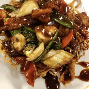 Pan fried noodles One of our most popular dishes. Chicken, beef, and shrimp with vegetables in brown sauce on top of a bed of fried lo mein