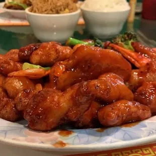 a plate of chicken wings and a bowl of rice