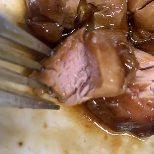 a plate of food with meat and gravy