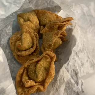 three fried food items on a piece of wax paper