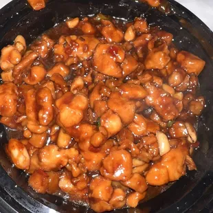 a plate of cashews in a sauce