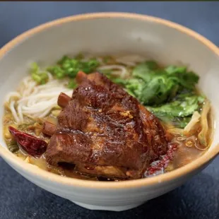 a bowl of noodles and meat