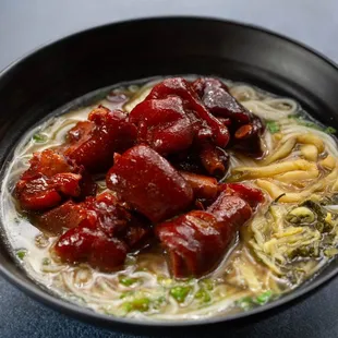 a bowl of noodles and meat