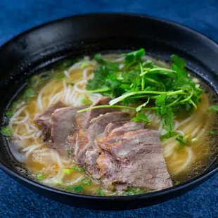 a bowl of beef and noodles