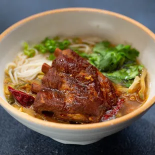 a bowl of beef and noodles