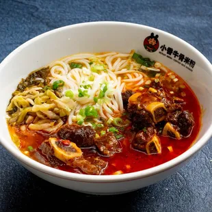 a bowl of noodles and meat