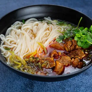 a bowl of noodles and meat