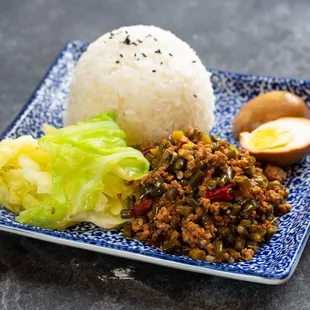 a plate of rice, meat and vegetables