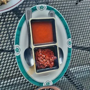 a plate of chili sauce and a bowl of rice