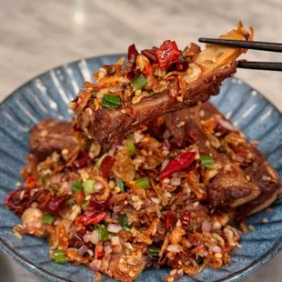 a plate of food with chopsticks
